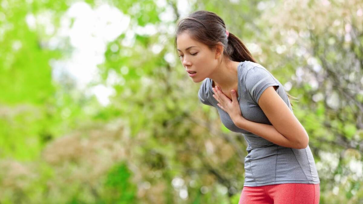 woman grabbing chest when running