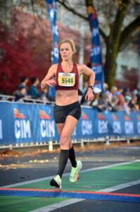 Whitney crossing a timing mat at the CIM 