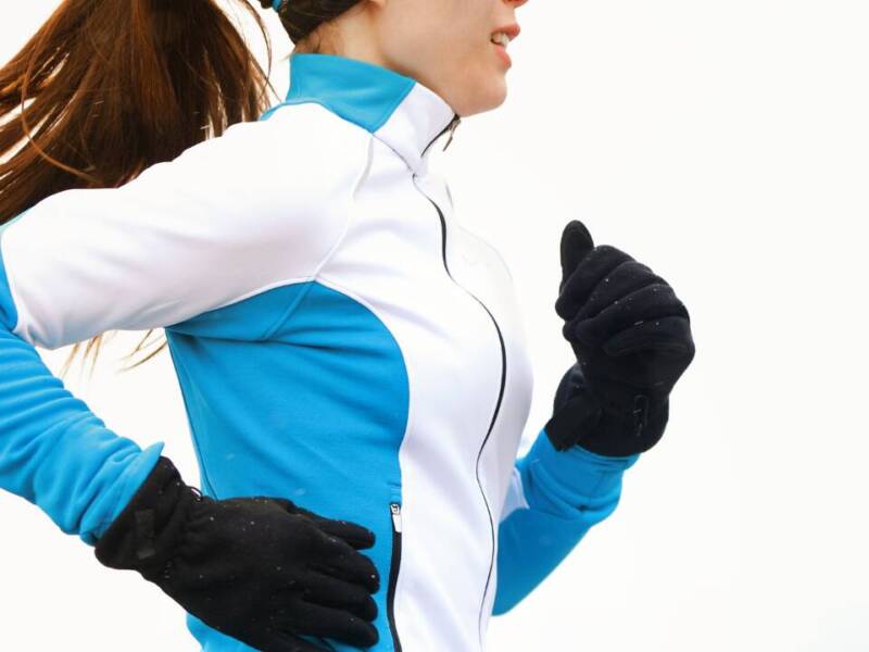 woman running in blue jacket