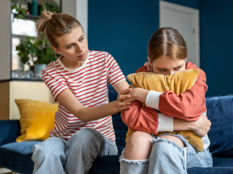 mom comforting daughter