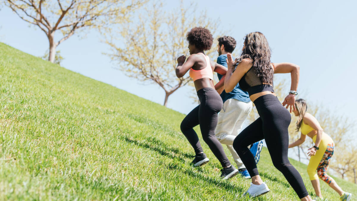 women running a grassy hill