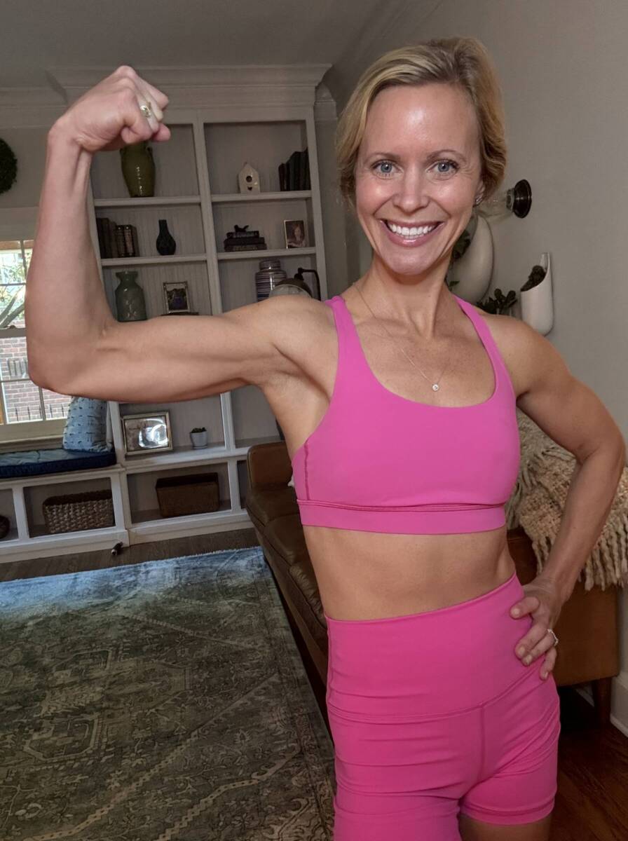 Whitney Heins flexing bicep wearing pink