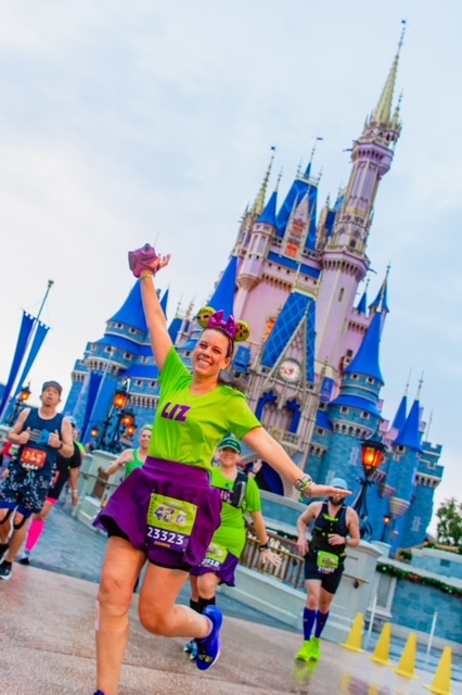 Elizabeth Minor in front of the Disney castle for a Disney race