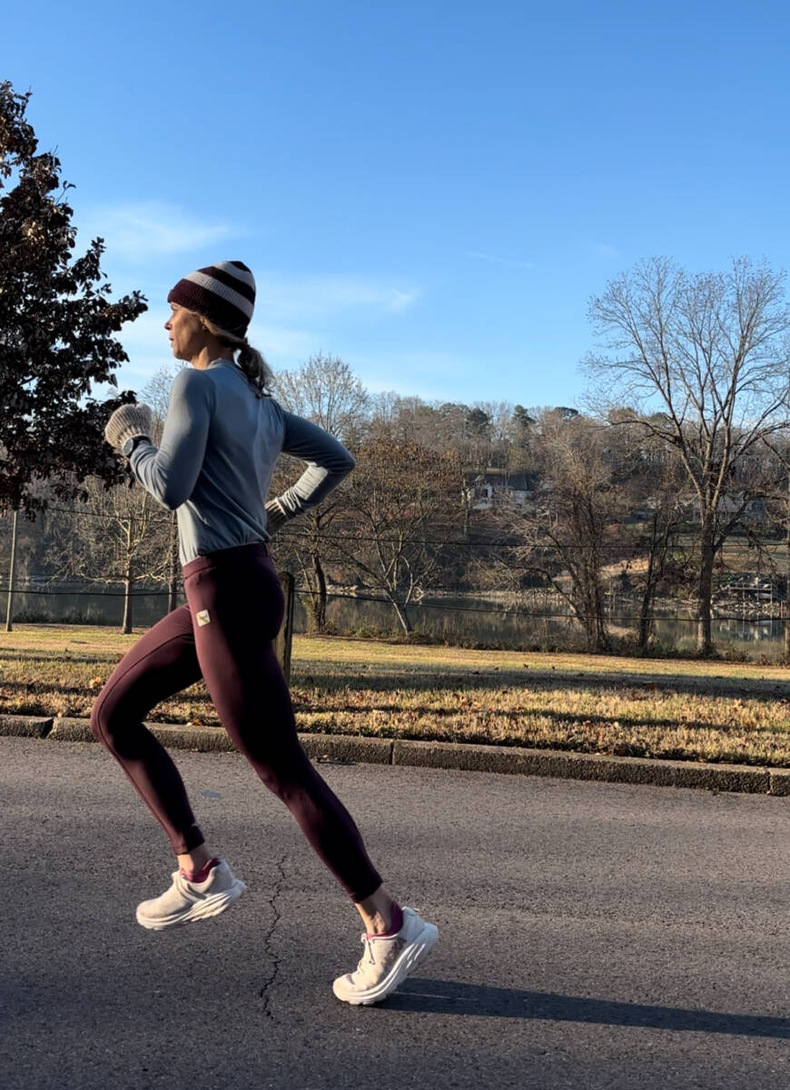 Whitney Heins running in a winter hat outside