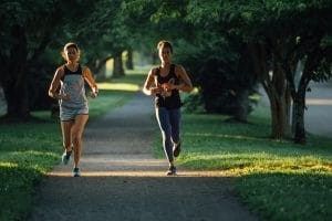 Two women running on a path