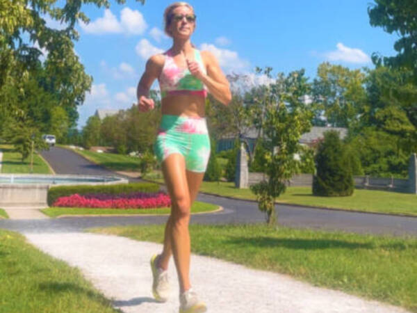 Whitney Heins running in tie-dyed outfit