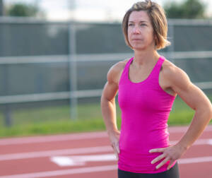 older woman in pink at track