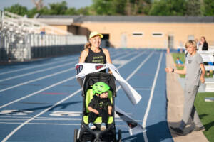 Neely Gracey sets the world record for the stroller mile in a time of 5:24. Breaking tape at track.