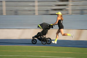 Neely Gracey sets the world record for the stroller mile in a time of 5:24. ushing stroller at track.