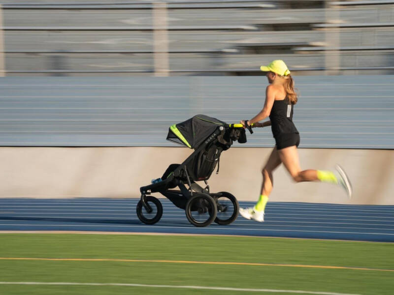 Neely Gracey sets the world record for the stroller mile in a time of 5:24. ushing stroller at track.